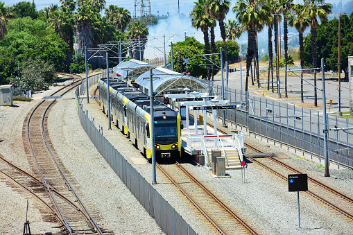 yellow train parked at the Artesia Station in sunny day in Los Angeles