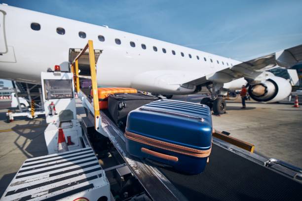 istock Loading of luggage to airplane 1266791141