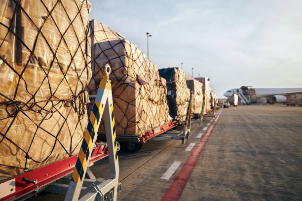 Loading of cargo airplane Loading of cargo containers to airplane at airport. cargo container stock pictures, royalty-free photos & images