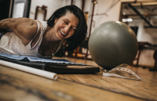 istock Group of women exercising pilates 1266792643