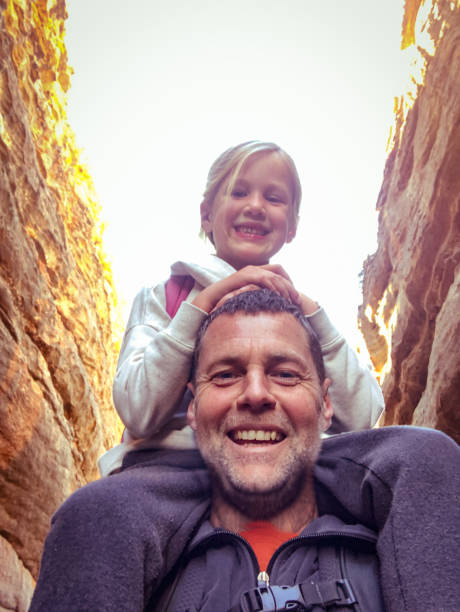 Dad with Daughter catching a ride on his shoulders smiling selfie  outdoors A Caucasian Dad with Daughter catching a ride on his shoulders smiling selfie  outdoors Wolfberg Cracks and Arch, Southern Cederberg Wildernis Area, Western Cape, South Africa cederberg mountains photos stock pictures, royalty-free photos & images