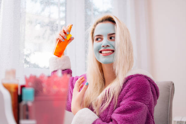 istock Woman holding spray for hair 1266792983