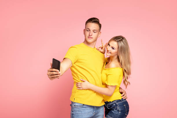 istock Two friends doing selfie by mobile phone. 1266795026