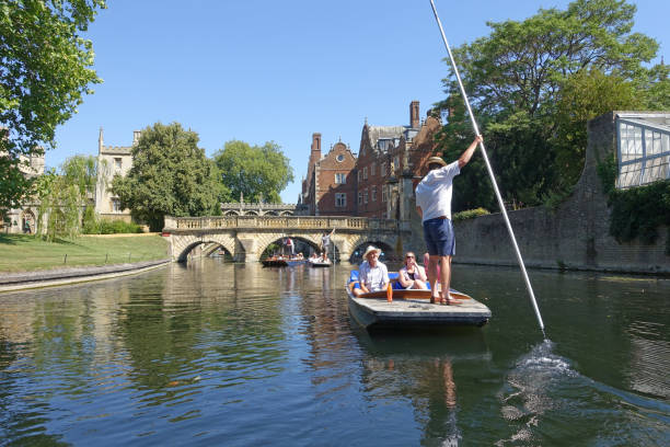 Punting along the backs in Cambridge Cambridge, UK 31 July 2020: Punting along the backs of the colleges on the river Cam in Cambridge punting stock pictures, royalty-free photos & images