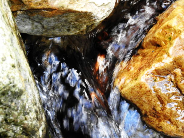 istock Water runs between the stones of the river 1266796002