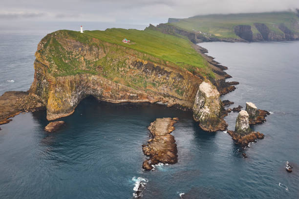Mykines lighthouse and cliffs on Faroe islands from helicopter Mykines lighthouse and cliffs on Faroe islands from helicopter. Denmark mykines faroe islands photos stock pictures, royalty-free photos & images