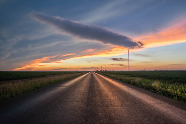 istock Blacktop road leading into sunset 1266799422