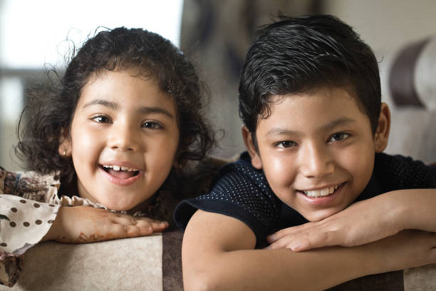 istock Brother and sister having fun at home 1266800997