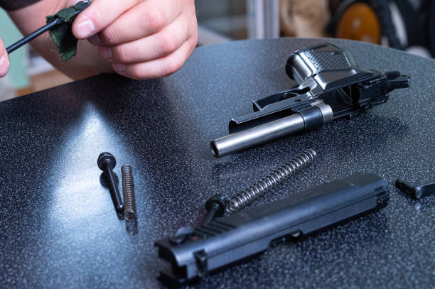 istock Assembling and disassembling the pistol at home. Maintenance of weapons at home. 1266803019