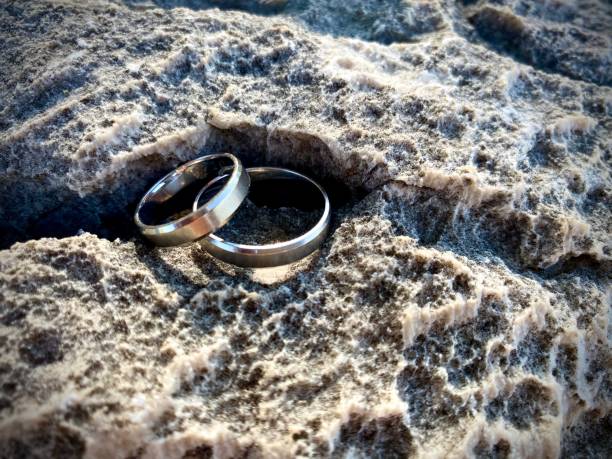 istock Two platinum Rings on the stone. Closeup shot : selective focus 1266805445