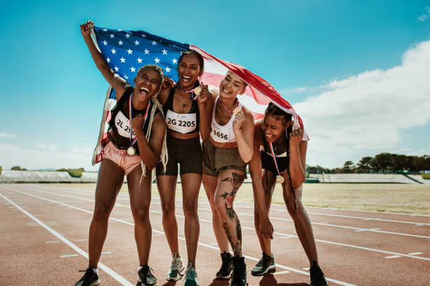 istock Team of athletes enjoying victory with US flag 1266806053