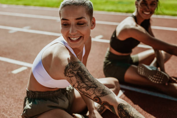 istock Runners stretching legs before a track event 1266806223