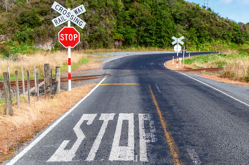 A stop sign at a rural rail crossing on New Zealand's north island.