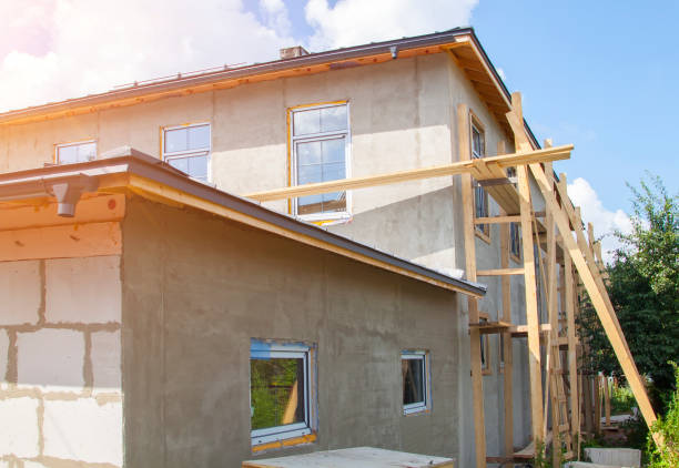 istock facade of cottage under construction covered with plaster with new windows inserted 1266807828