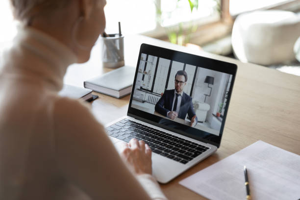 istock Focus on computer screen with confident coach giving consultation. 1266809617