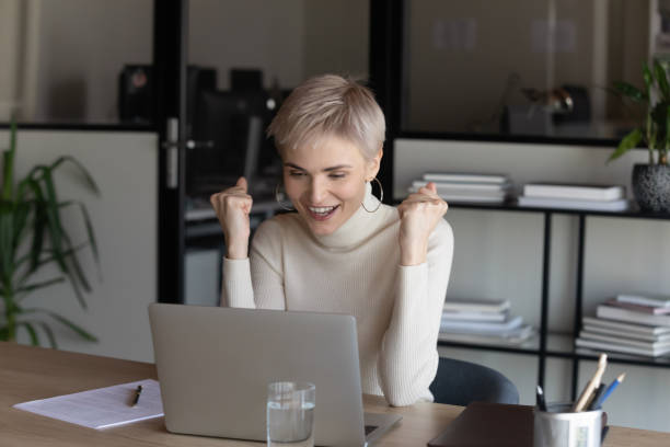 istock Happy young blonde female executive manager making yes gesture. 1266809622