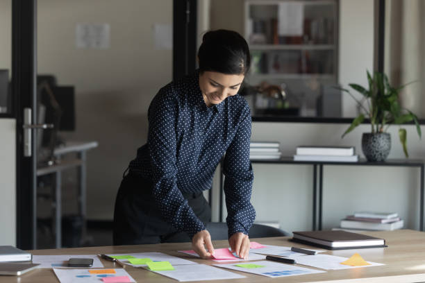 istock Smiling young smart indian employee preparing economics sales reports. 1266809668