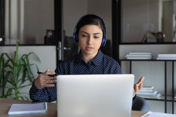 istock Focused young indian ethnicity speaker giving educational online lecture. 1266809677
