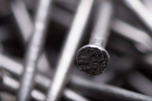 Metal nail with shadow in shape of cross