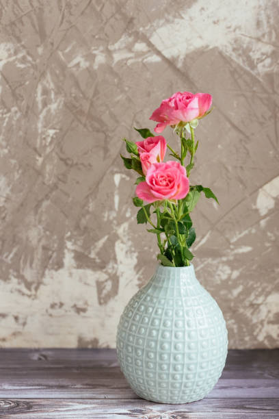 istock flowers in a vase on a brown background 1266809809