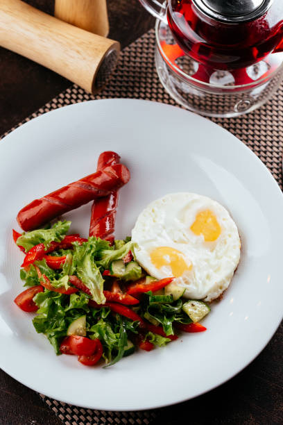 istock vegetable salad, fried sausage and egg 1266810139