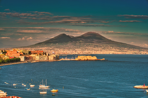 Beautiful sunrise over the Bay of Naples with the Castel dell'Ovo in front of the famous Mt. Vesuvio. The Castel dell' Ovo is the oldest standing fortification in Naples.