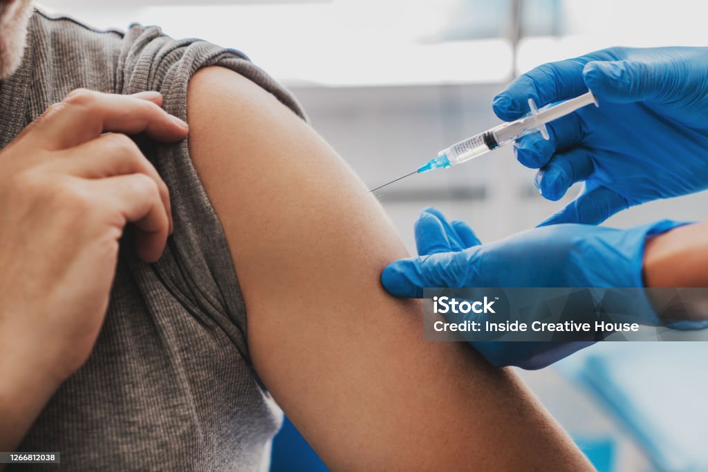 Vaccination of senior person in hospital Vaccination Stock Photo