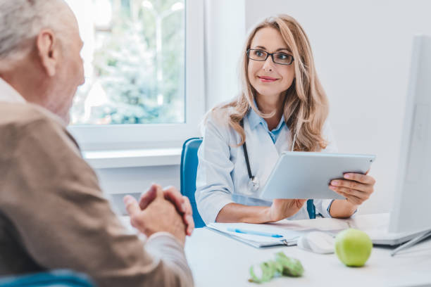 dietetyk lekarza w średnim wieku w białym płaszczu medycznym konsultuje się ze swoim starym pacjentem za pomocą cyfrowej tabletki - diabetes doctor zdjęcia i obrazy z banku zdjęć