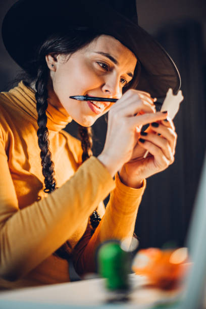 istock Young woman makes Halloween garland 1266812202