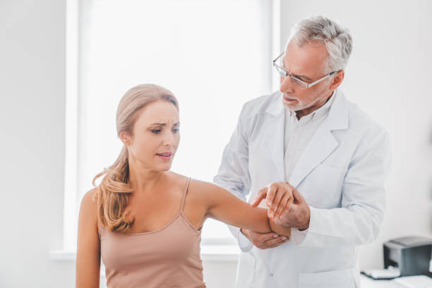 istock Orthopedist examining patient in hospital 1266812402
