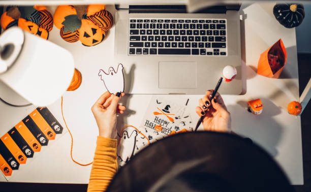 istock Laptop and halloween preparation 1266812462