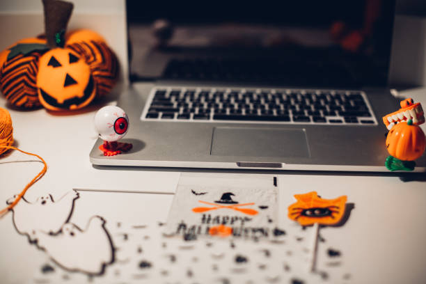 istock Laptop and halloween preparation 1266813058