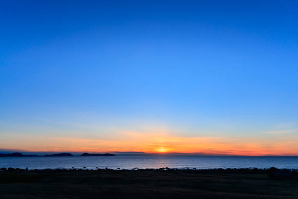 ALNES, NORWAY - 2017 MARCH 05. Sun goes into the ocean makes a beautiful sunset.