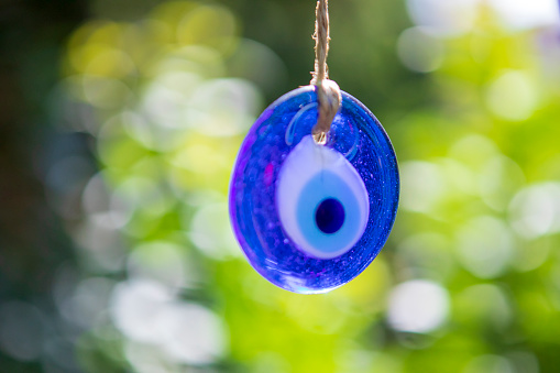 Evil eye beads hanging on tree stock photo
