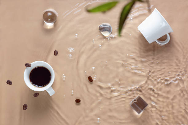 Hot coffee is splashing in cup. water and beans are blending