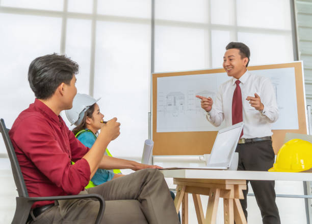 istock Construction Boss is congratulating his team for successfull project meeting. 1266817761