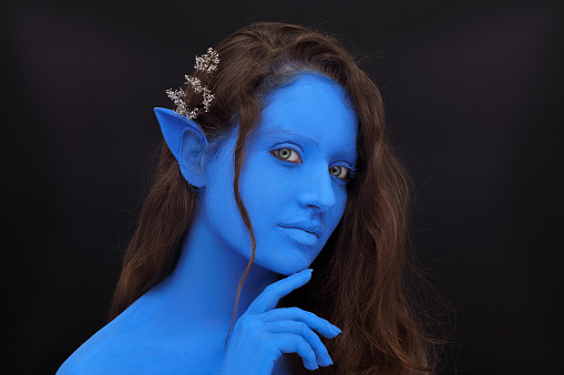 Elf girl with blue skin and ears, cosplay.
