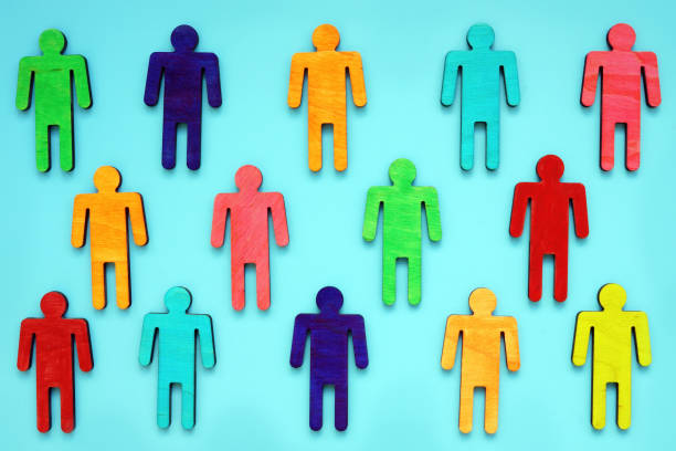 istock Diversity and variety concept. Multi-colored figurines of people on a blue background. 1266819565