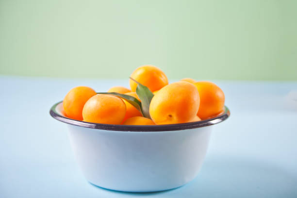 istock Fresh ripe apricot on the enameled plate 1266821620