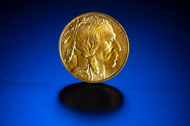 istock Gold 1 oz. $ 50. indian head coin on blue 1266821937