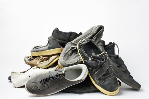 A pair of worn, vintage styled, classic sneakers isolated on white background. File contains clipping path.