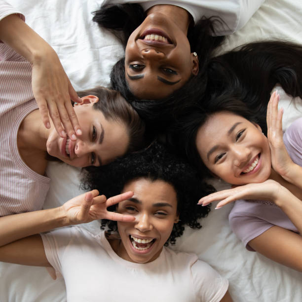 istock Above view multiethnic girls faces lying down having fun indoors 1266822023