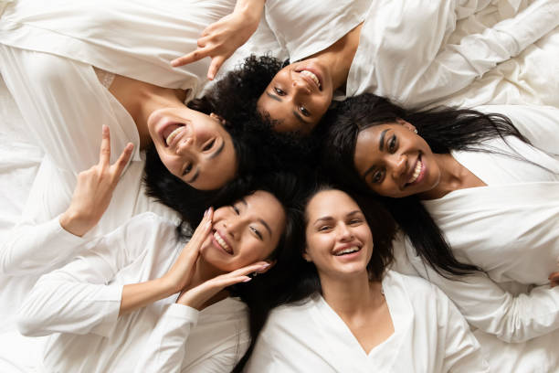 istock Diverse women lying in bed feels happy after spa procedures 1266822048