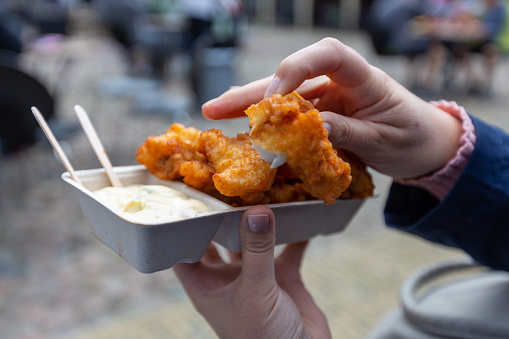 Franeker, The Netherlands. 29th of July 2020: Delicious fried fish called kibbeling, served with sauce in Franeker