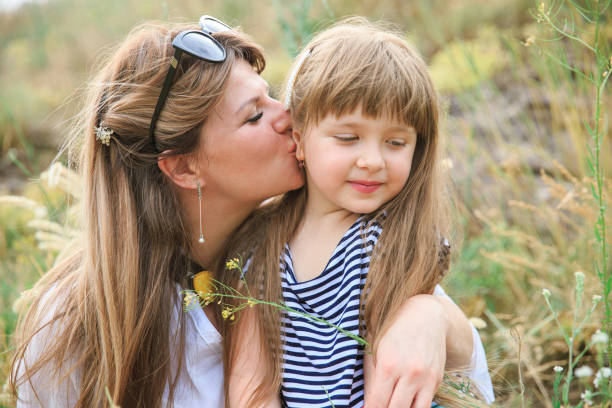 istock Joyful mom and daughter sit in the open air 1266823070