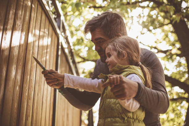 istock Teaching her how to apply lacquer in the wooden wall 1266823510