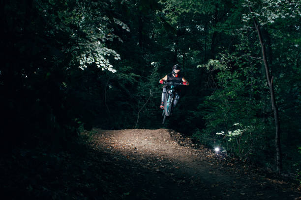 istock Extreme mountain biker jumping on a forest track 1266824456