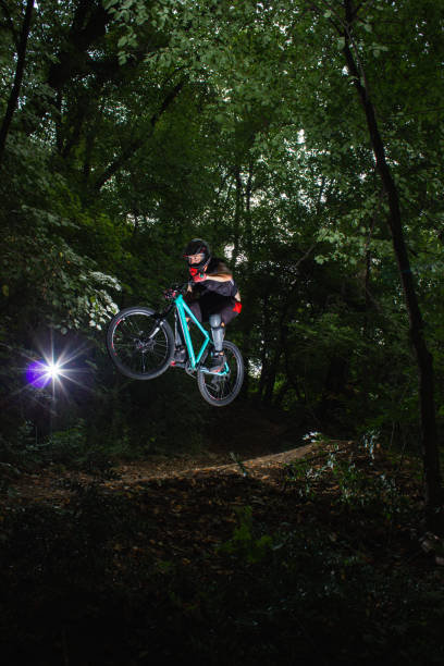 istock Extreme mountain biker jumping on a forest track 1266824675