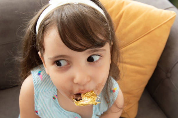 istock Little girl eating chocolate 1266825908