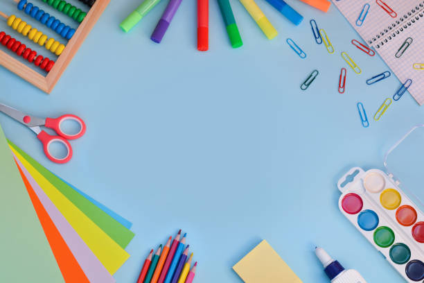 school stationery on blue background with copy space. back to school. flat lay - arte e artesanato imagens e fotografias de stock